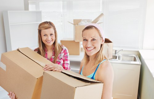 Professional movers carrying furniture through a building